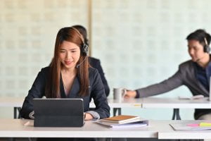 A woman on a call with a wireless VoIP headset