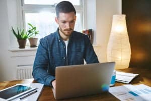 A man typing on his work laptop