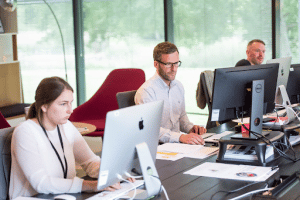 Three people working at their desks