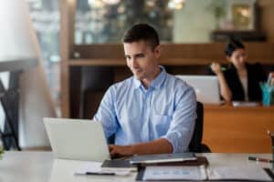 Man sitting on computer using G12 Operator Connect for Microsoft Teams.