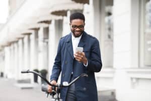 A man smiles at his phone while using Operator Connect for Microsoft Teams